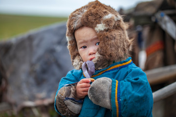 tundra, The extreme north, Yamal, the pasture of Nenets people, children on vacation playing near reindeer pasture - obrazy, fototapety, plakaty