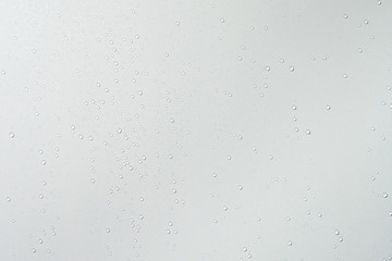 Water drops on white surface background.