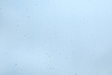 Water drops on blue surface background.