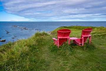 Two Red Adirondack Chairs at Green Point, Overlooking the Gulf of St. Lawrence, Newfoundland