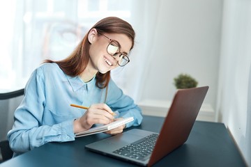young woman working on laptop at home