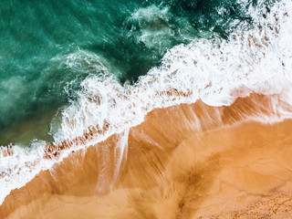 Crashing waves onto a Kauai beach. White brown crisp sand and white waves of the water crashing onto the shore.  - 289611599