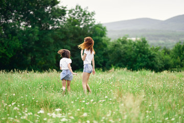 Fototapeta premium mother and daughter in the field