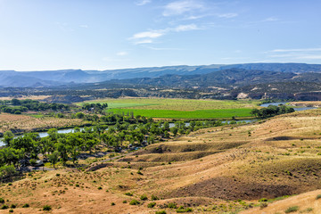 Aerial high angle view of Green River Camground in Dinosaur National Monument Park with camp site, green farm plants in Utah, USA