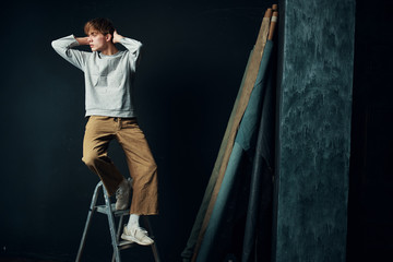 Obraz na płótnie Canvas young man climbing a ladder
