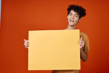 young man holding a blank board