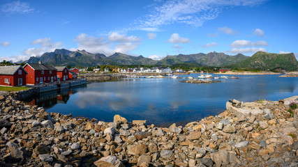 Panoramic view, Red hut with a blue sky reflecting the water at Kabelvaag In the Lofoten Islands, northern Norway.