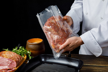 The chef wraps the meat in a vacuum bag