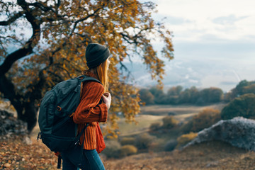 girl with backpack in mountains