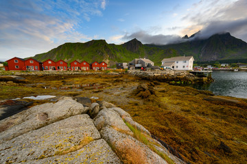 Red village with beautiful nature in the evening at ballstad city, lofoten island in northern Norway.