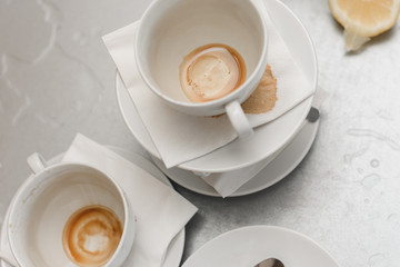 dirty cups with stains from coffee and tea on a metal table in the kitchen in the office
