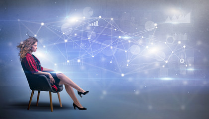 Elegant woman sitting in a sofa with network and connection concept