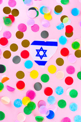 Flag Israel Magen David Star heart shape and holidays colorful confetti on pink background.Welcome Israel, Israeli love.