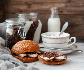 sandwich with chocolate-milk paste, bananas and nuts with coffee on a white table