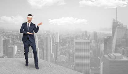 Young suited karate trainer doing karate tricks on the top of a metropolitan city