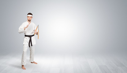 Fototapeta na wymiar Young kung-fu trainer fighting in an empty space