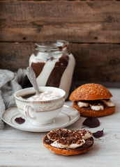 sandwich with chocolate-milk paste, bananas and nuts with coffee on a white table