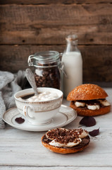 sandwich with chocolate-milk paste, bananas and nuts with coffee on a white table