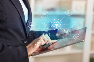 Business woman using tablet with network security and online storage system concept