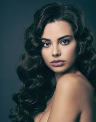 Beautiful young woman with long curly brown hair