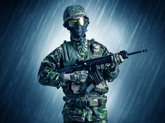 Armed soldier standing in rainy weather