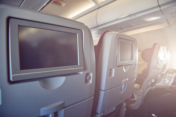 Modern airplane passenger seat with touch - screen.