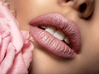 Closeup sexy female lips with pearl lipstick. Women's lips and pearl flower - obrazy, fototapety, plakaty