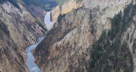 Yellowstone Lower Falls river grand canyon. Upper and Lower falls. National Park in Wyoming geothermal ecosystem environment. Biology, geography and ecology. Millions of tourist and visitors.