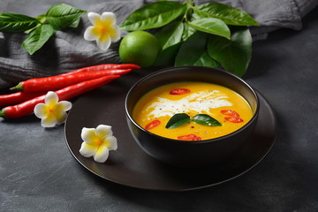 Thai spicy pumpkin and coconut milk soup with kaffir lime leaves , red chilli and galangal roots powder. Vegan, healthy food, gluten-free. Paleo- diet