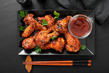 Baked chicken wings with sesame and sauce. Traditional asian recipe. 