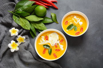 Thai spicy pumpkin and coconut milk soup with kaffir lime leaves , red chilli and galangal roots powder. Vegan, healthy food, gluten-free. Paleo- diet
