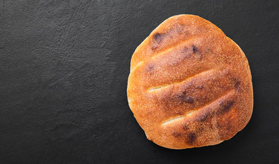 Fototapeta na wymiar Fresh hot focaccia bread (pita) on black stone background.