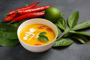 Thai spicy pumpkin and coconut milk soup with kaffir lime leaves , red chilli and galangal roots powder. Vegan, healthy food, gluten-free. Paleo-diet