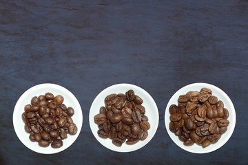 top view variety of roasted and green coffee beans on rustic background