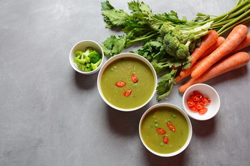 Healthy Vegan Creamy blended vegetable Soup puree with broccoli, celery, peas and carrots . Green detox soup concept. Low-fat lunch.