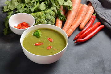 Healthy Vegan Creamy blended vegetable Soup puree with broccoli, celery, peas and carrots . Green...