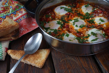 Shakshouka, Middle East and North Africa Dish of Poached Eggs in a Sauce of Tomatoes, Chili Peppers and Spices