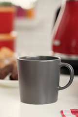 Cup of tea or coffee on modern kitchen background