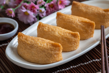 Rice ball wrapped in deep fried tofu pouches ( Inari Sushi), Japanese food.