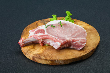 Raw pork bone steak over wooden