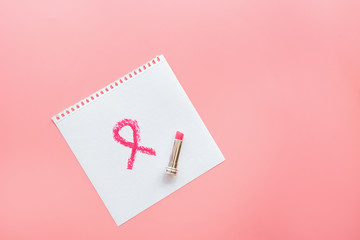 Breast Cancer Awareness symbol to promote in october month campaign painted with pink lipstick. Flat lay with copy space, top view, mockup, overhead, template. Health care concept