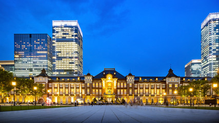Tokyo railway station and Tokyo modern highrise building at twilight time. Chiyoda city, Tokyo, Japan. Host city of the Olympic Games 2020.