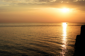 Magnificent sunrise over the sea and beautiful cloudscape on the coast of Sicily. Cefalu, Italy