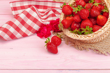 Plate of strawberry on pink wooden background