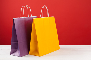 Paper shopping bags with copy space on red background