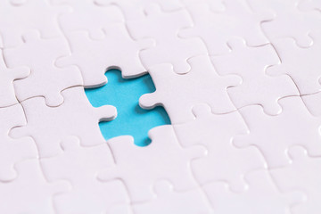 Unfinished jigsaw puzzle on blue background with copy space for your text or content , Working concepts separated from groups