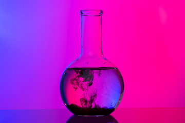 Obraz na płótnie Canvas Laboratory glass tubes with chemicals on bright pink background