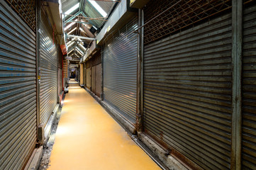 Fototapeta premium Row of shop business closed metal roller shutters