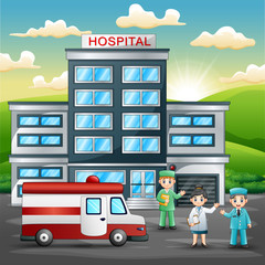 Doctors and nurse standing in front of hospital building with ambulance