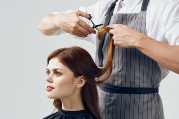 Fototapeta premium hairdresser cutting hair with scissors